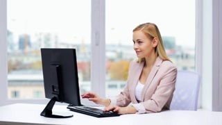 Businesswoman Typing on Computer at Office