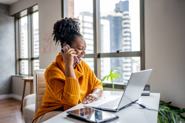 Black woman talking on the phone at home