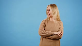 Surprised woman points fingers to ad with promotional offer